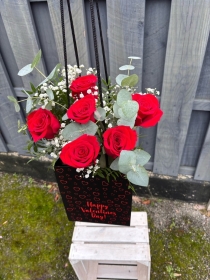 Six roses in a vase